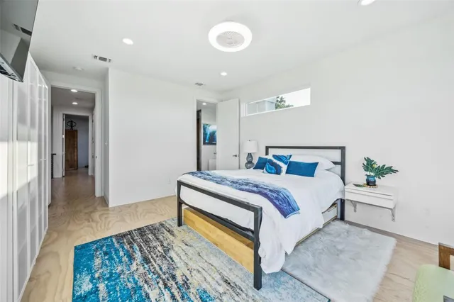 a bathroom with a tub a sink and a large mirror