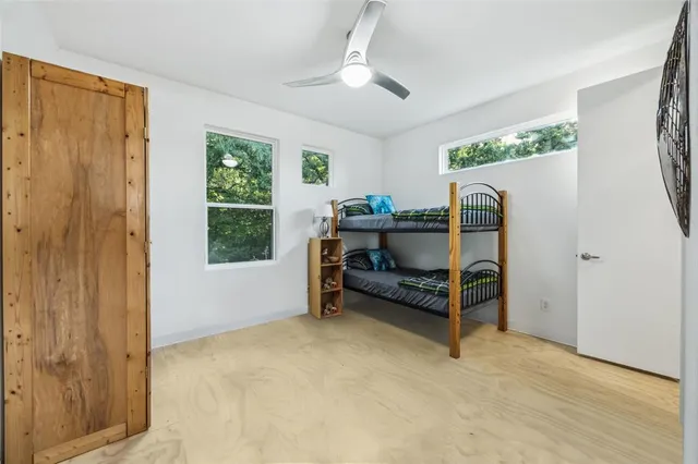 a bedroom with furniture and a flat screen tv