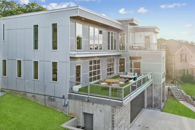 a view of a house with a yard and potted plants