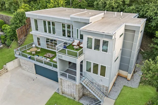 an aerial view of a house with a yard