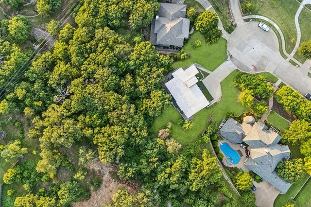 an aerial view of a house with a yard and garden