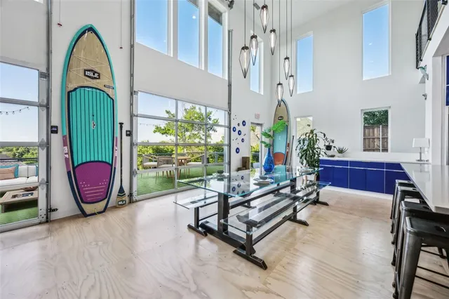 a living room with patio furniture and a large window