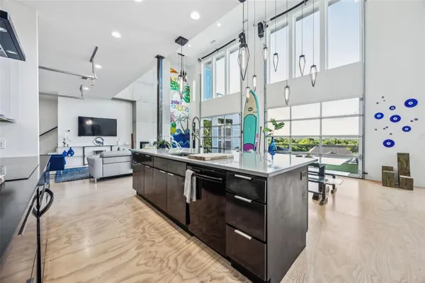 a kitchen with stainless steel appliances kitchen island granite countertop a stove and a sink