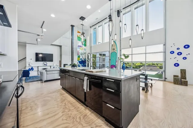a kitchen with stainless steel appliances kitchen island granite countertop a stove and a sink