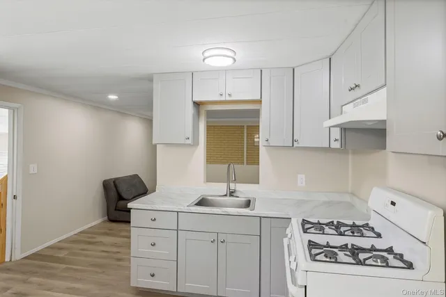 a kitchen with a refrigerator and a stove top oven