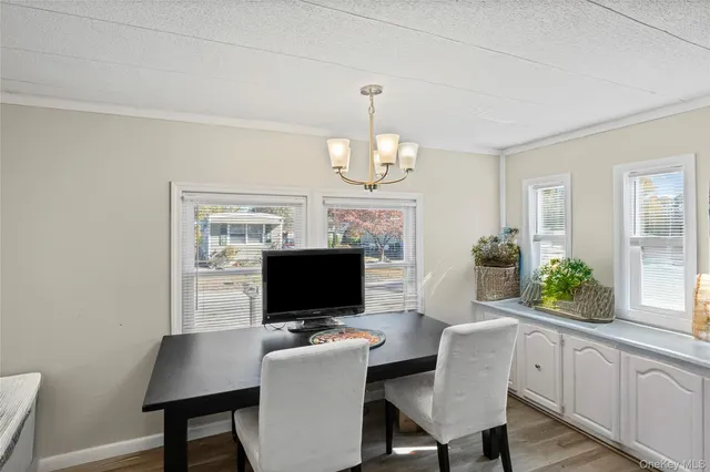 a kitchen with stainless steel appliances granite countertop a stove a sink dishwasher and a fireplace with wooden floor