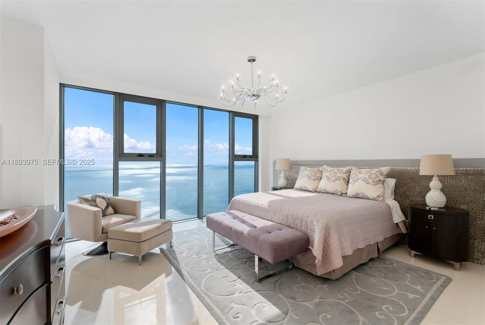 6899 Collins Avenue, Unit LPH04 Miami Beach, FL 33141 - Photo 12 of 29 a bedroom with a bed and a large window