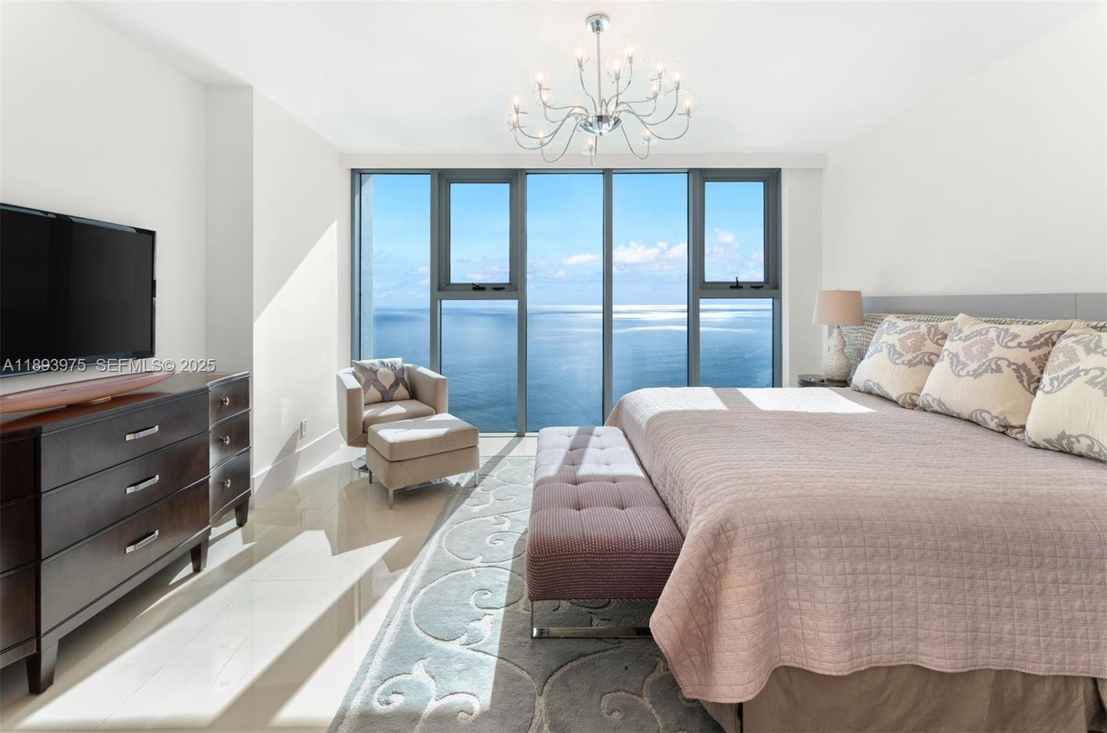 6899 Collins Avenue, Unit LPH04 Miami Beach, FL 33141 - Photo 13 of 29 a bedroom with a bed and a flat screen tv