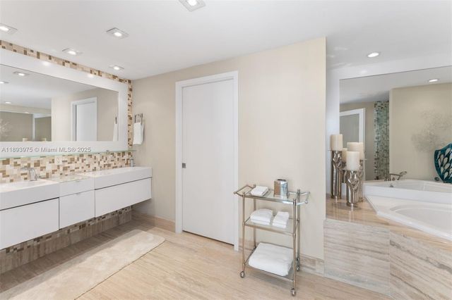 a bathroom with a bathtub and a shower