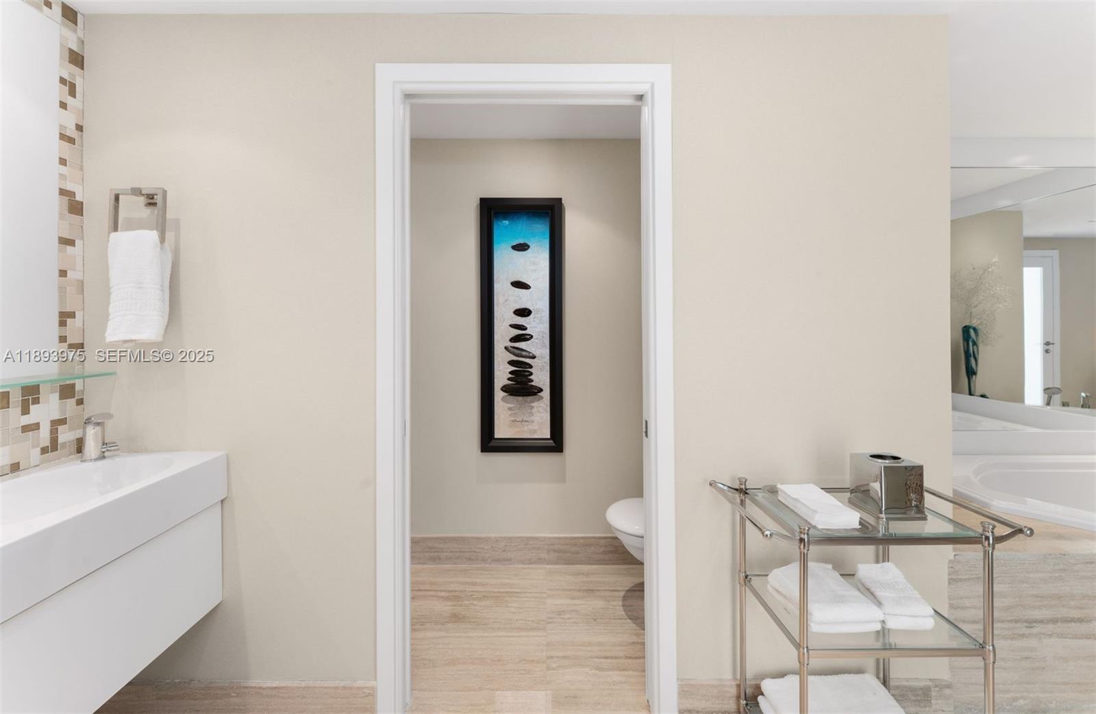 6899 Collins Avenue, Unit LPH04 Miami Beach, FL 33141 - Photo 17 of 29 a bathroom with a sink and a mirror