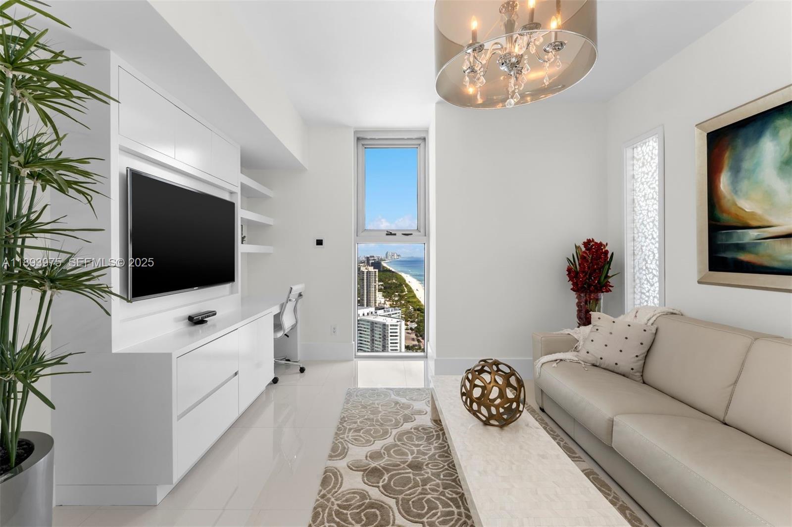 6899 Collins Avenue, Unit LPH04 Miami Beach, FL 33141 - Photo 20 of 29 a living room with furniture and a flat screen tv
