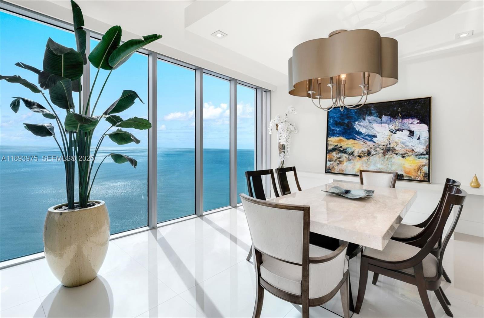 6899 Collins Avenue, Unit LPH04 Miami Beach, FL 33141 - Photo 5 of 29 a dining room with furniture and a potted plant