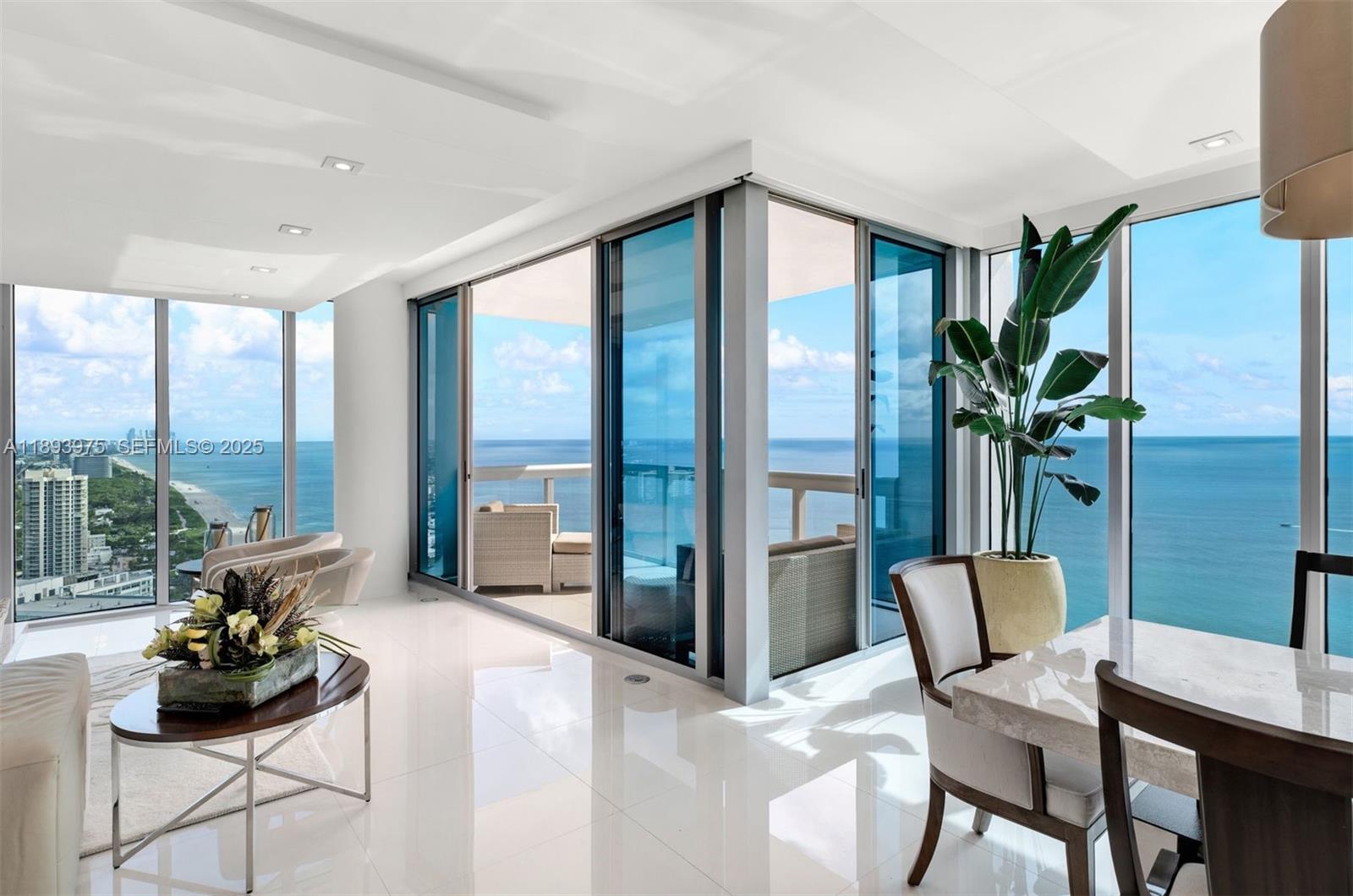 6899 Collins Avenue, Unit LPH04 Miami Beach, FL 33141 - Photo 6 of 29 a dining room with furniture and large windows
