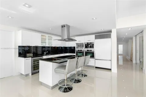 a kitchen with stainless steel appliances a sink and cabinets