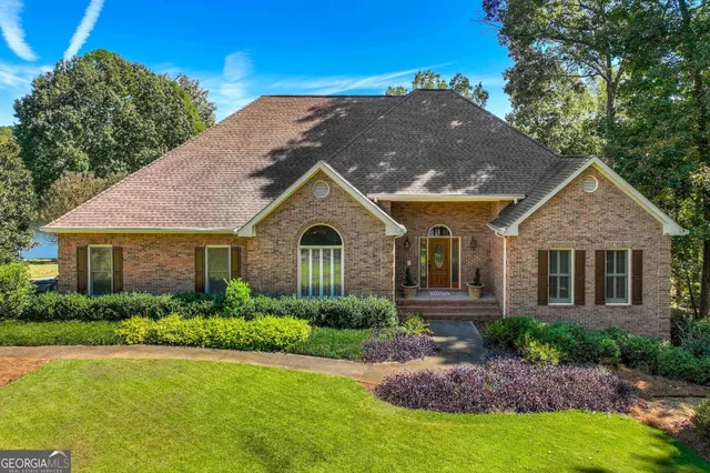 a front view of a house with a garden