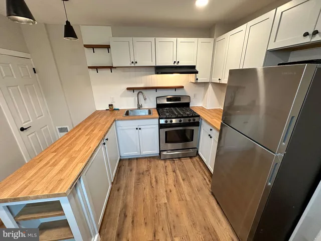 a kitchen with a refrigerator a sink and dishwasher