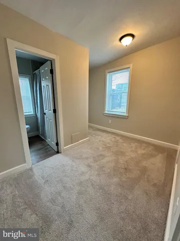 an empty room with closet and mirror