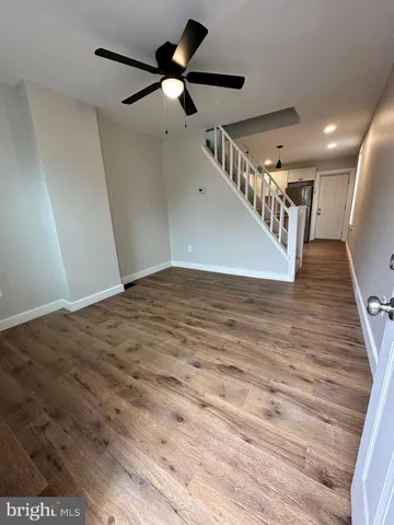 a view of a hallway with a ceiling fan