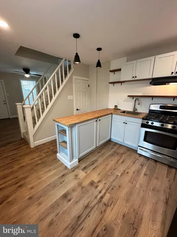 a view of kitchen with sink and wooden floor