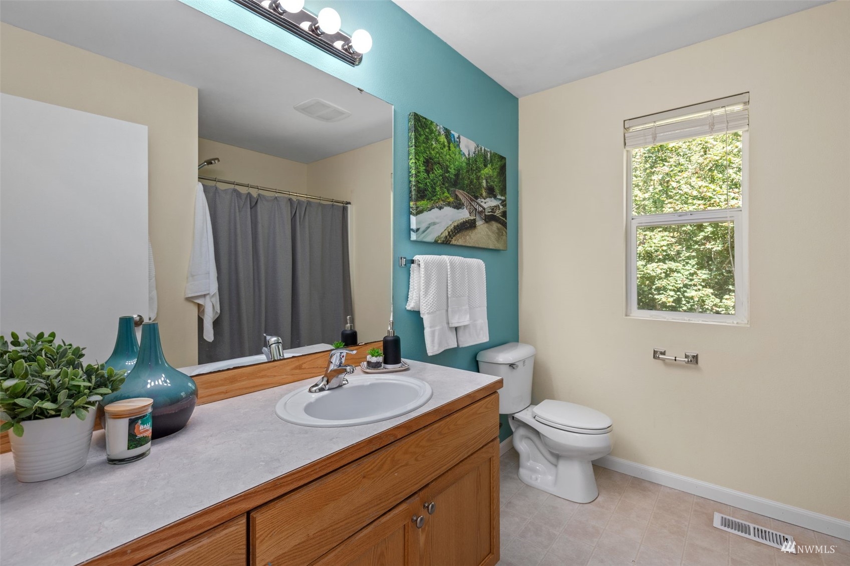 2321 Stafford Way Bothell, WA 98012 - Photo 30 of 38 a bathroom with a granite countertop sink a large mirror and a toilet