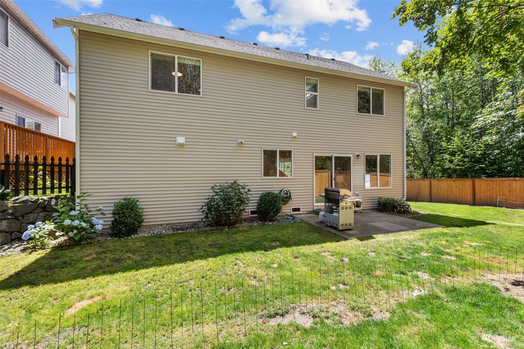 2321 Stafford Way Bothell, WA 98012 - Photo 33 of 38 a view of a house with backyard sitting area and garden