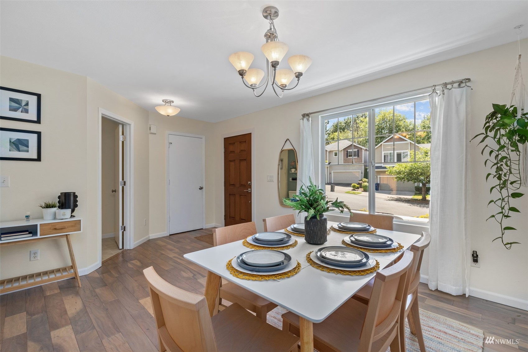 2321 Stafford Way Bothell, WA 98012 - Photo 4 of 38 a view of a dining room with furniture a chandelier and wooden floor