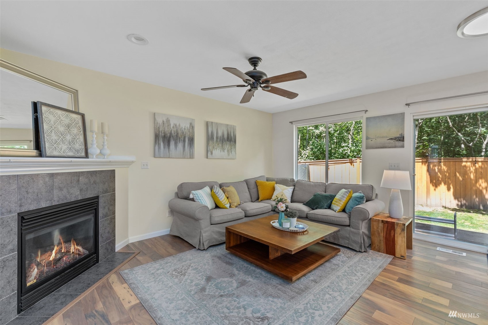 2321 Stafford Way Bothell, WA 98012 - Photo 5 of 38 a living room with furniture a fireplace and a floor to ceiling window