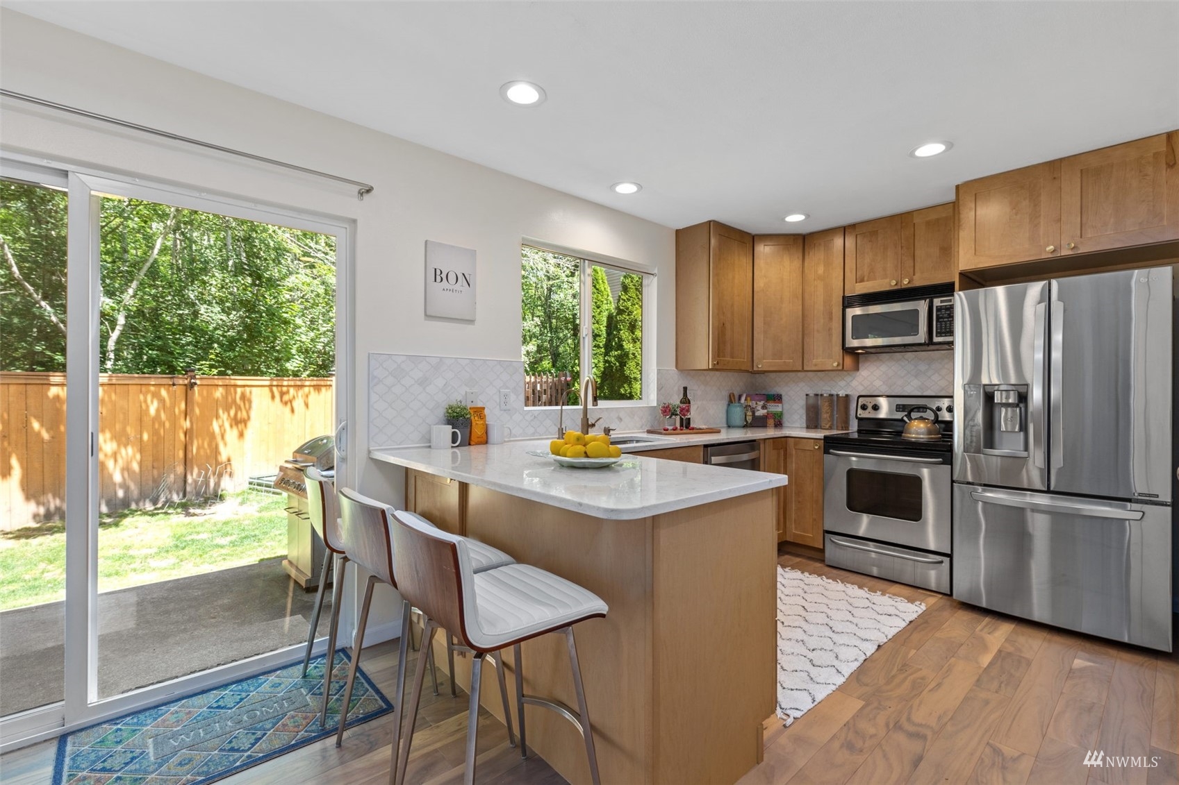 2321 Stafford Way Bothell, WA 98012 - Photo 8 of 38 a kitchen with kitchen island wooden cabinets and refrigerator