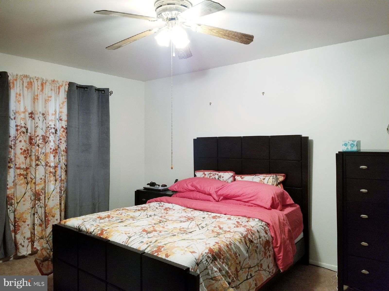 1101 Marksworth Road Baltimore, MD 21207 - Photo 14 of 29 a bedroom with a bed and a chandelier