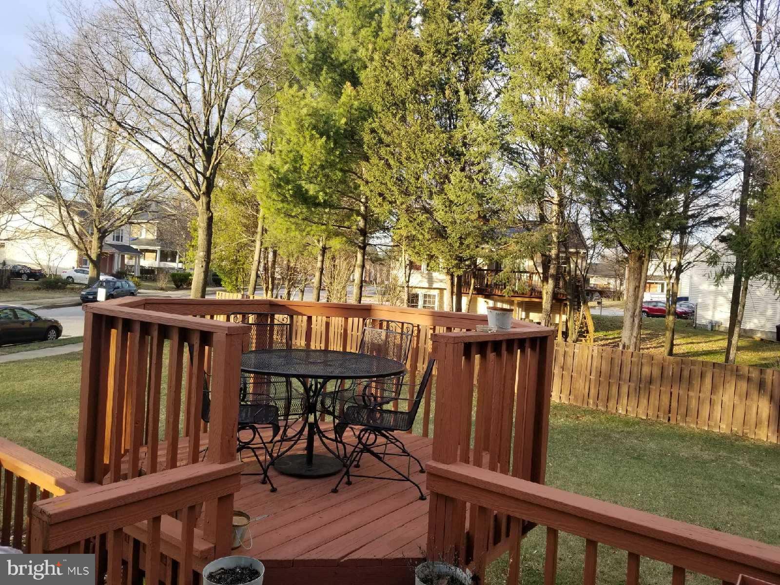 1101 Marksworth Road Baltimore, MD 21207 - Photo 3 of 29 a view of a wooden deck with chairs and a yard