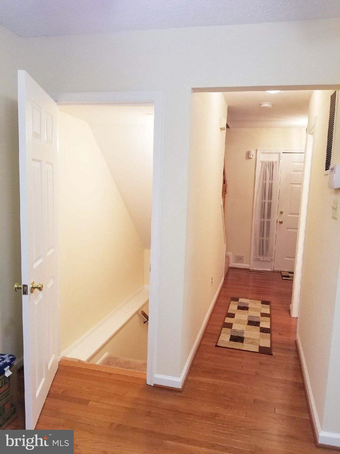 1101 Marksworth Road Baltimore, MD 21207 - Photo 23 of 29 a view of a hallway with wooden floor and staircase