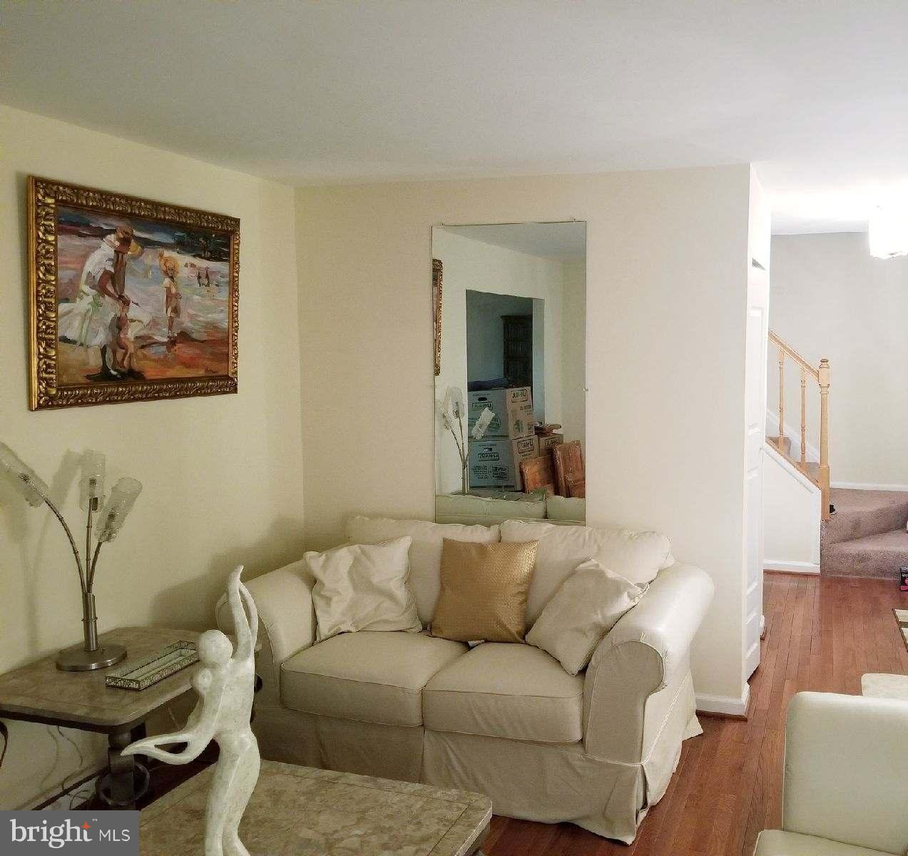 1101 Marksworth Road Baltimore, MD 21207 - Photo 7 of 29 a living room with furniture and a painting on the wall