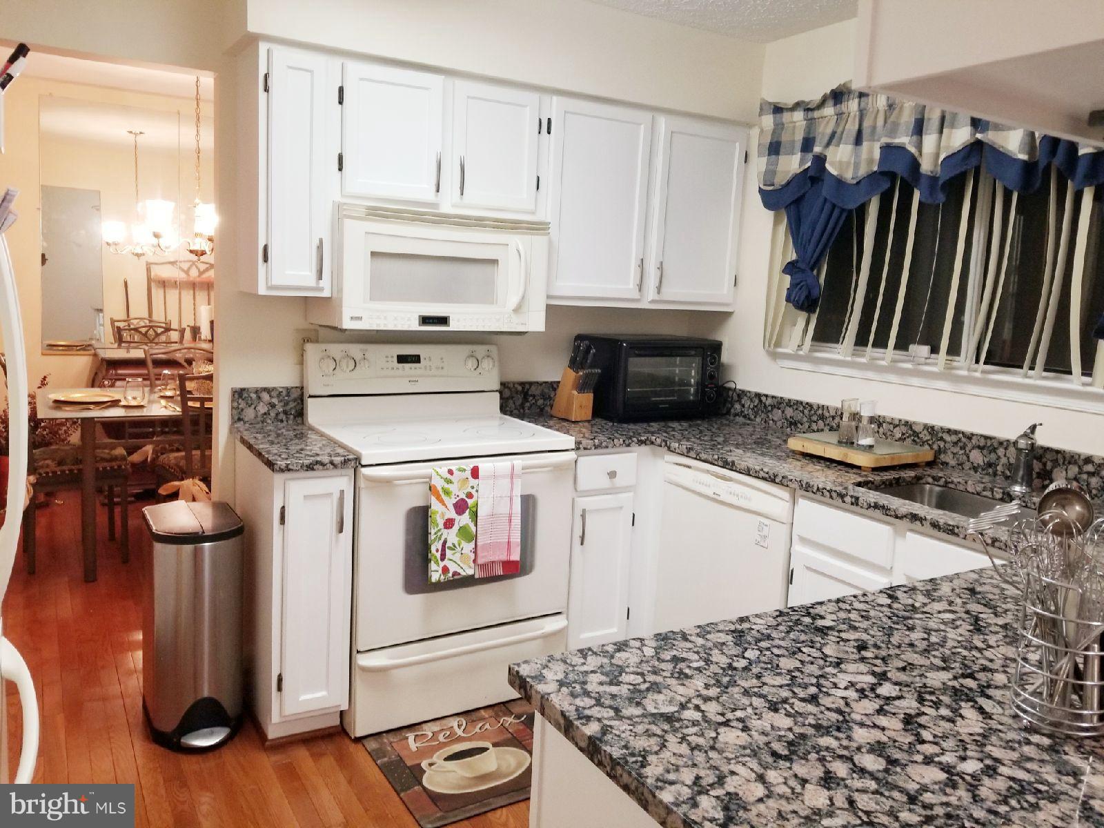 1101 Marksworth Road Baltimore, MD 21207 - Photo 10 of 29 a kitchen with stainless steel appliances granite countertop a stove and a microwave