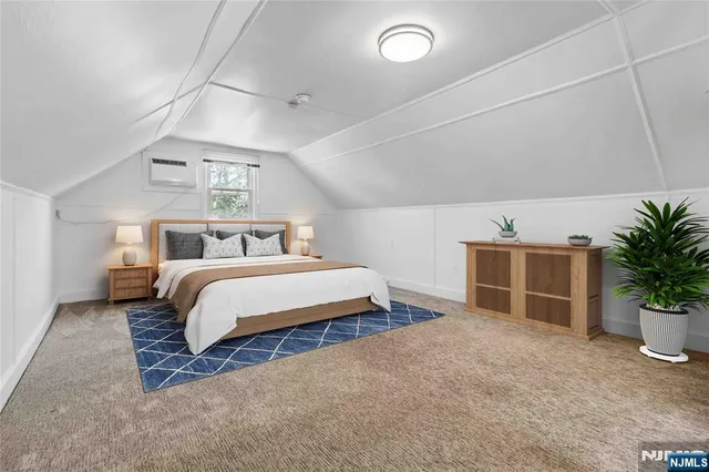 a bedroom with a bed and a potted plant