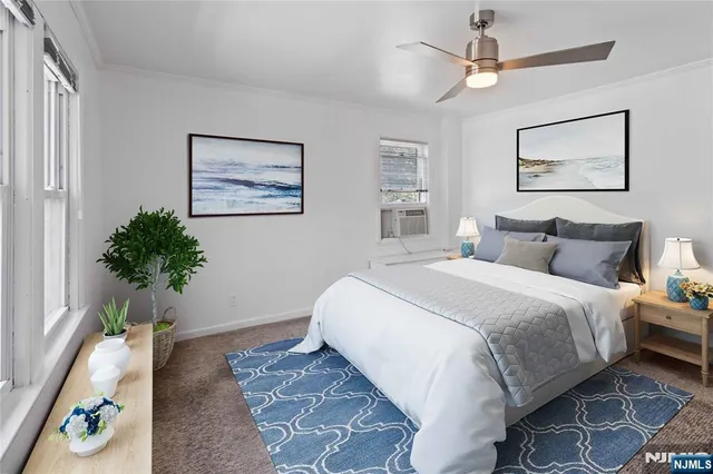 a bedroom with bed and a potted plant