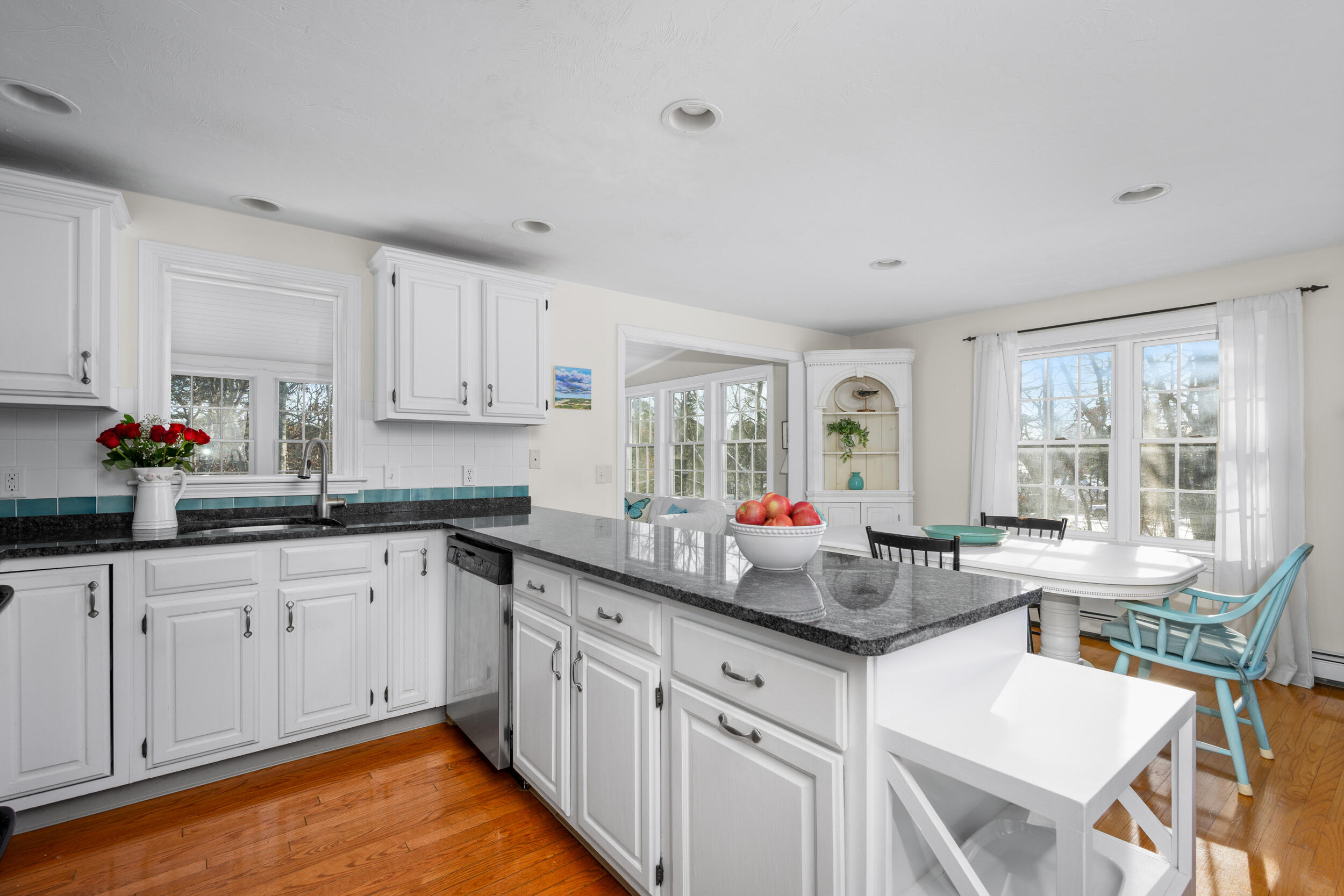 36 Island Street East Dennis, MA 02660 - Photo 2 of 41 a kitchen with white cabinets and sink