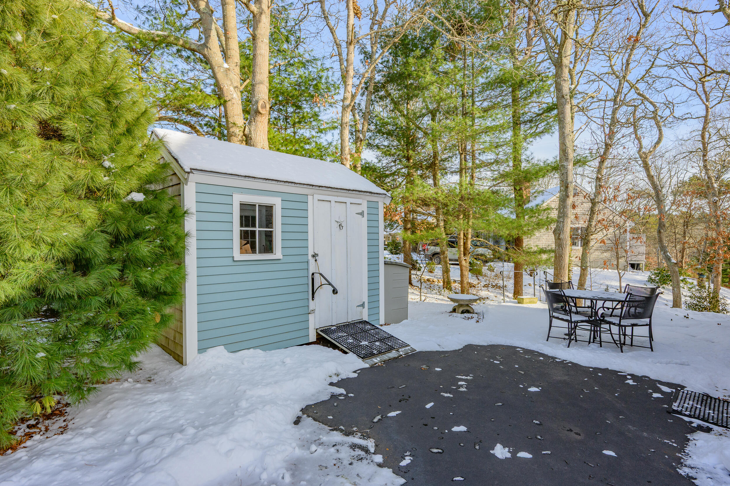 36 Island Street East Dennis, MA 02660 - Photo 36 of 41 a backyard of a house with table and chairs