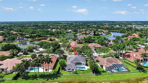 a view of swimming pool with outdoor seating and green space