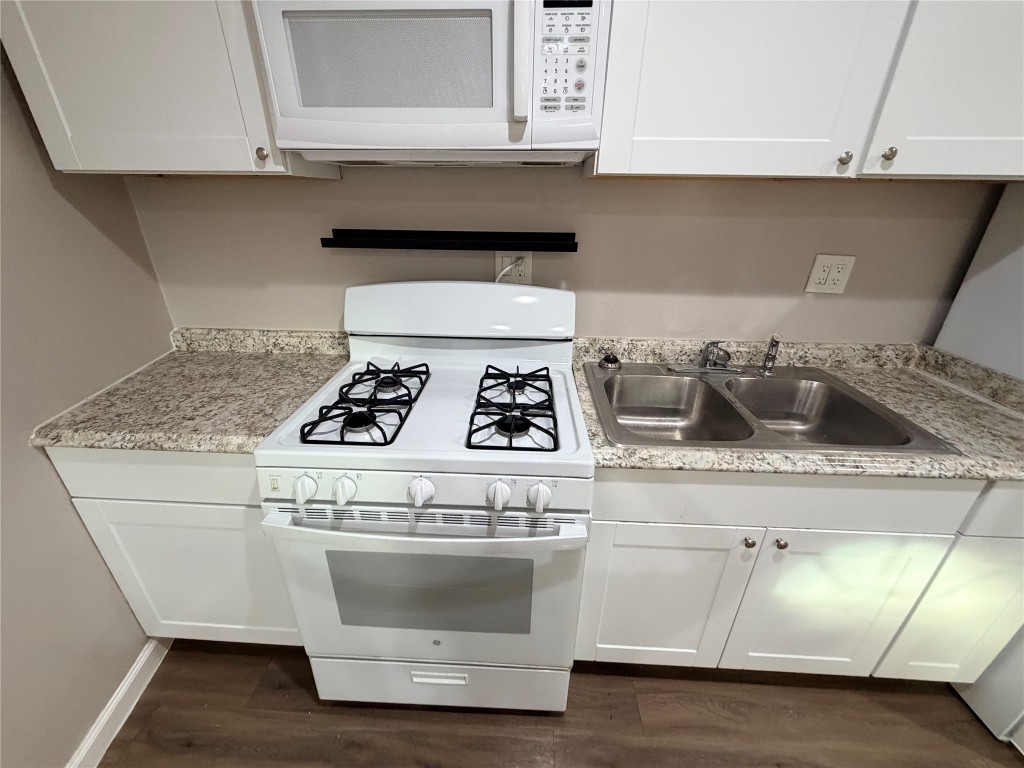 13217 Player Street, Unit B Houston, TX 77045 - Photo 20 of 22 a white stove top oven sitting inside of a kitchen