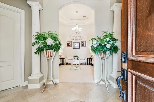 a view of a dining room with furniture and chandelier