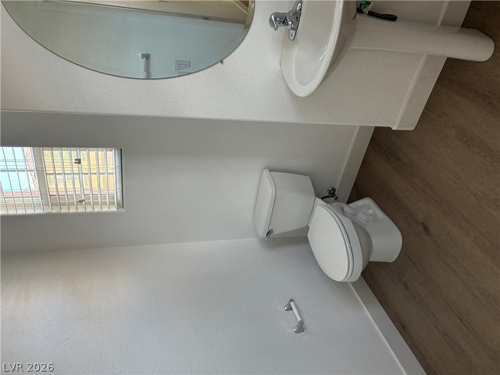 7727 Pista Way Las Vegas, NV 89179 - Photo 8 of 12 A well-lit bathroom provides functionality and privacy with a clean aesthetic.