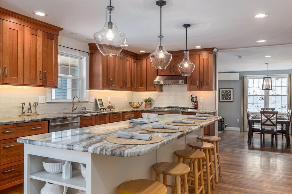24 Wheeler Road Bolton, MA 01740 - Photo 1 of 28 a kitchen with a dining table and chairs