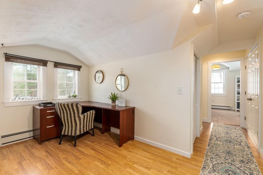 24 Wheeler Road Bolton, MA 01740 - Photo 15 of 28 a view of a livingroom with furniture wooden floor and windows
