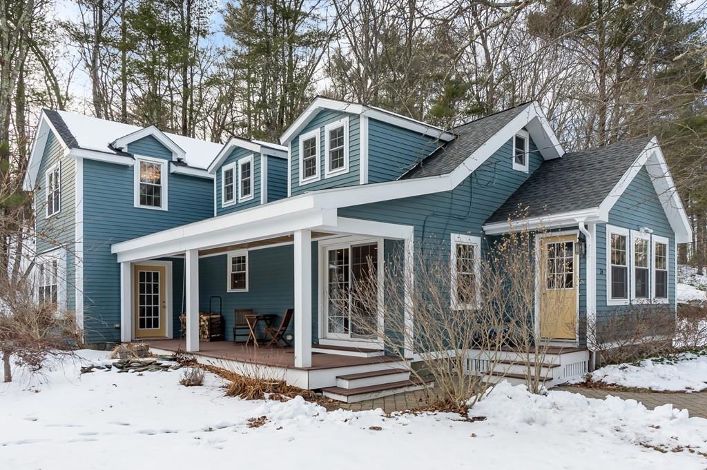 24 Wheeler Road Bolton, MA 01740 - Photo 23 of 28 a front view of a house with a yard and glass windows