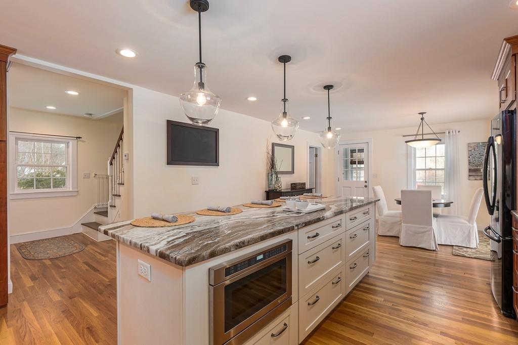 24 Wheeler Road Bolton, MA 01740 - Photo 3 of 28 a kitchen with stainless steel appliances granite countertop a stove and a wooden floor