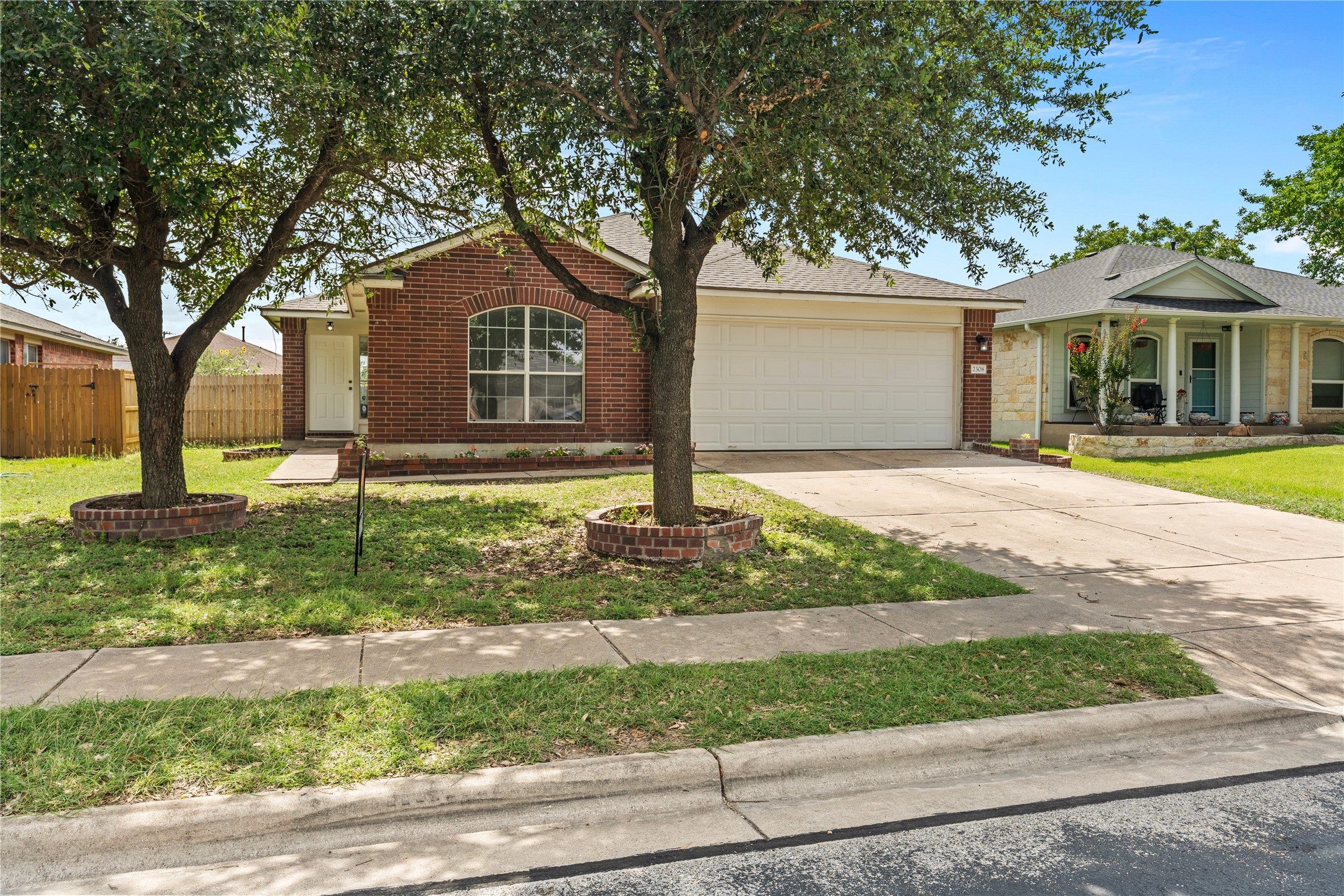 2308 Butler Way Round Rock, TX 78665 - Photo 1 of 1 A well-maintained brick facade home awaits, featuring an inviting arched window and an attached two-car garage.