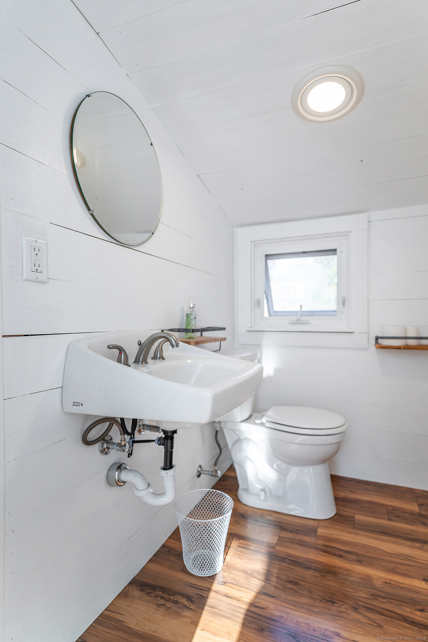 5 Windmill Road New Fairfield, CT 06812 - Photo 25 of 37 a bathroom with a toilet a sink and mirror