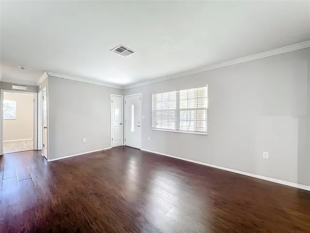 a kitchen with stainless steel appliances granite countertop a sink a stove cabinets and wooden floor