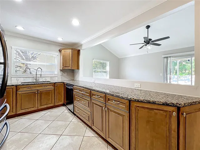 a kitchen with granite countertop a sink and a window