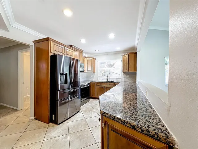 a view of an empty room with windows & cabinet fan